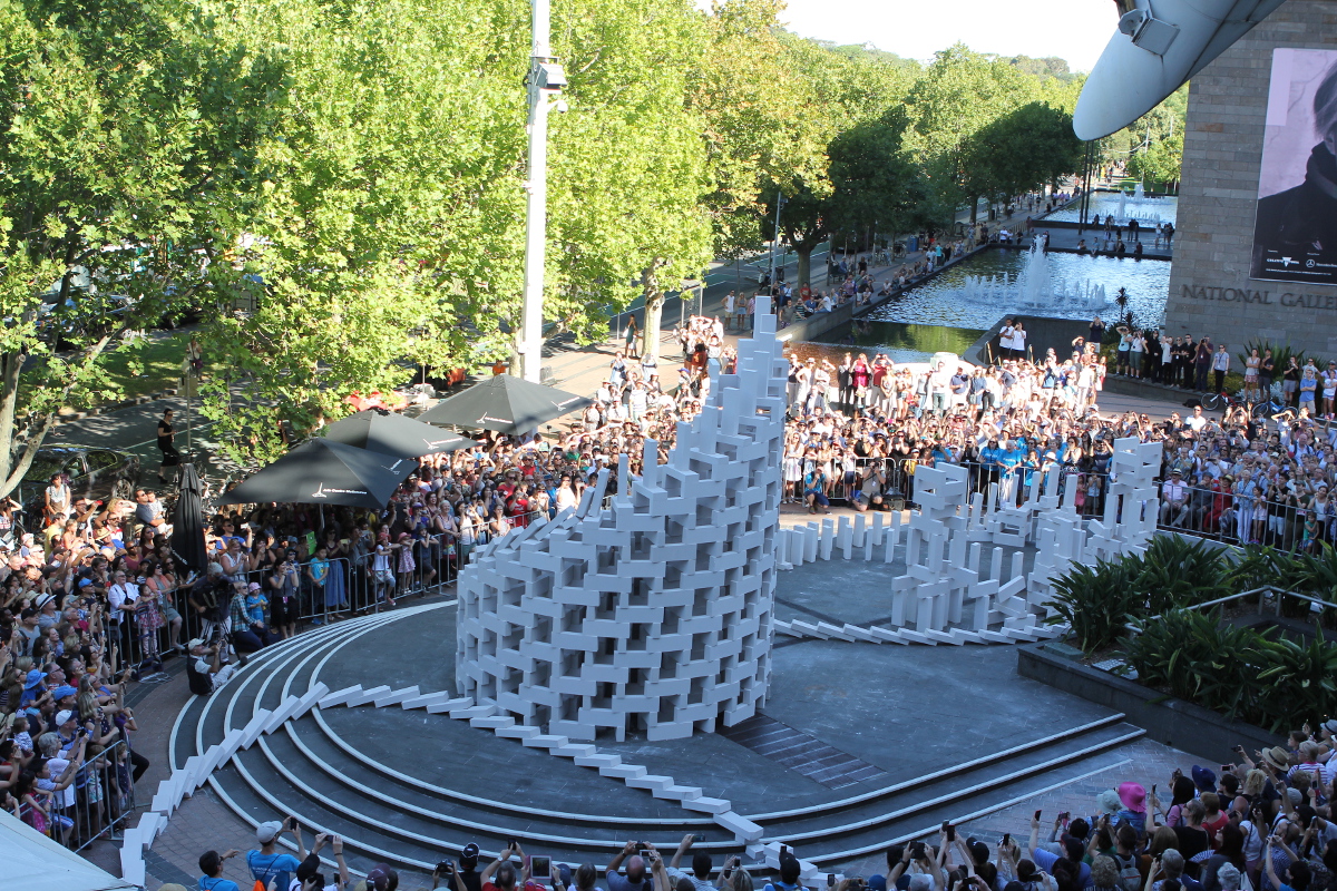 Tower of toppling breeze blocks displayed outside in Melbourne. A performance by Station House Opera.