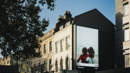 An image of a roadside billboard showing the artwork 'Home is far away’ (2022) by Ian Wainaina