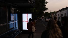An image of a bus stop digital screen showing the artwork ‘Fragile’ (2023) by op.x.