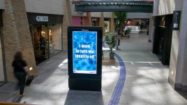 An image of a digital screen in a shopping centre showing the artwork ‘I Want to Turn my Identity Off’ (2023) by Lori Gordon