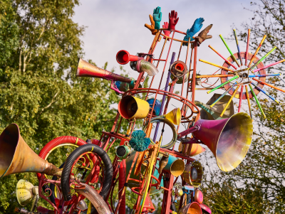 A close up of the tip of The Babylon Gamelan by Rag & Bone, created by artist Dave Young, 2024. Horns, gloves, bike wheels and all sorts of reclaimed and repainted junk are attached to the 4 metre tall structure. Photo by Andrew Moore