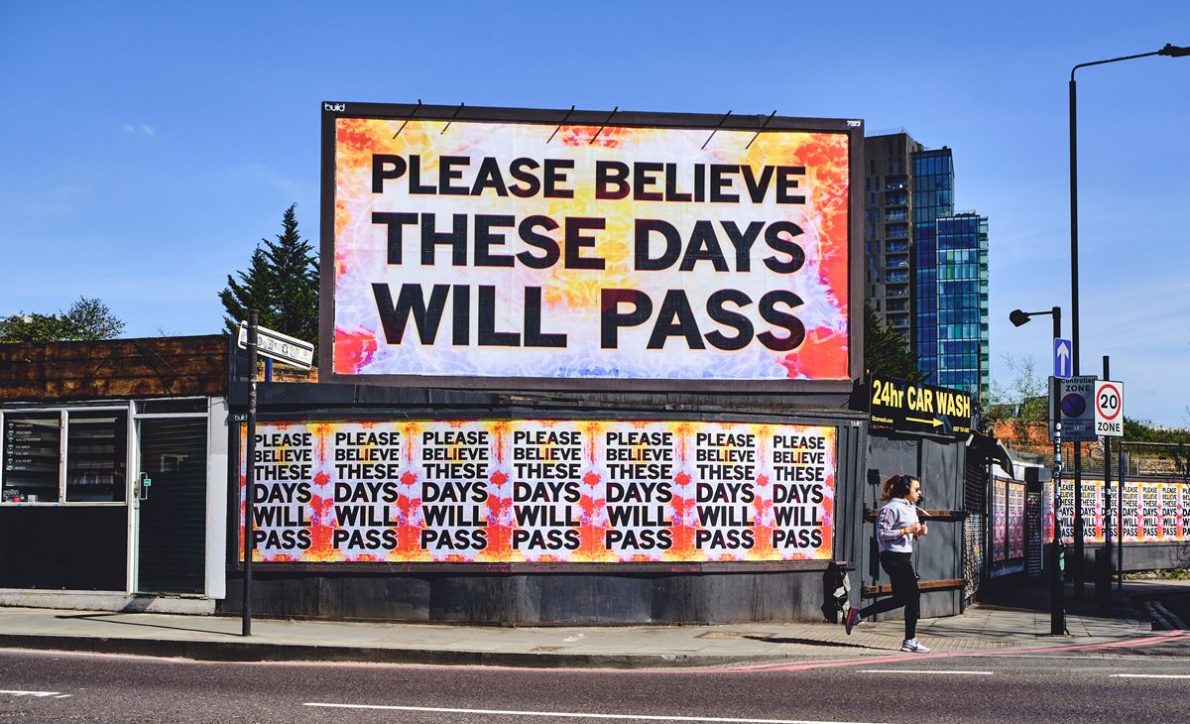 A large billboard and multiple posters display the message 